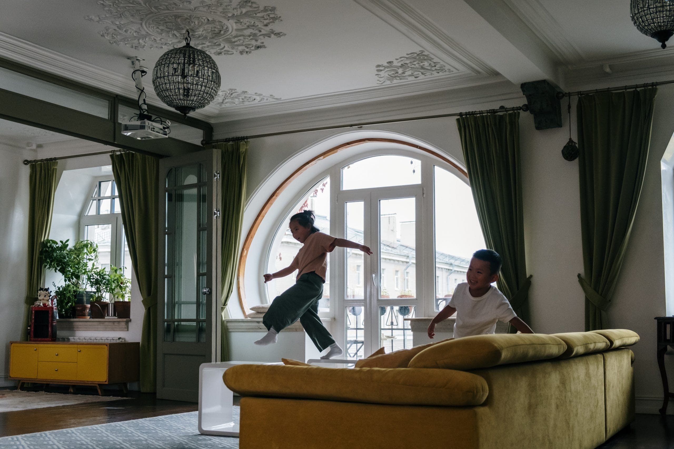 child jumping off the sofa in a living room